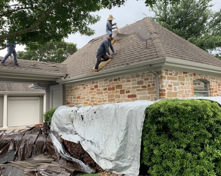 A&W Roofing contractors laying out new shingles on a Central Texas home.