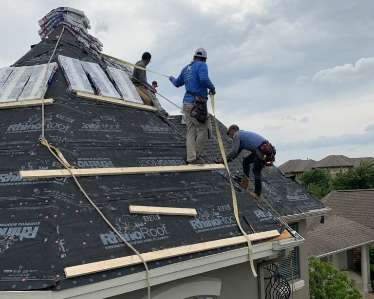A&W Roofing contractors working on a new roof installation on a Central Texas home.