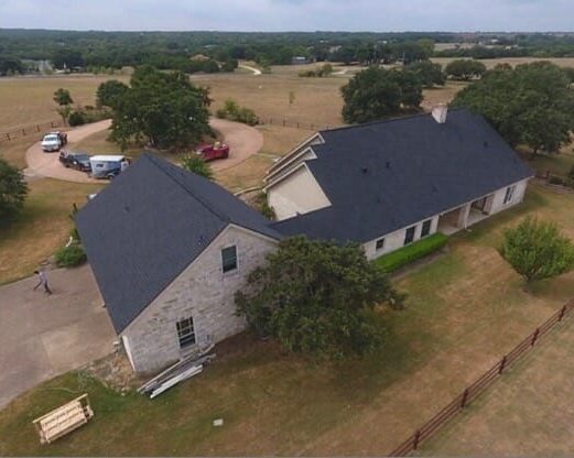 Limestone home in Central Texas with newly installed shingle roof.
