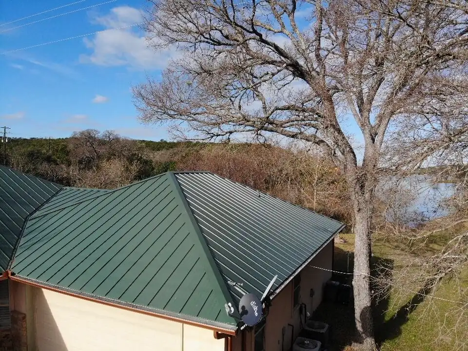 Green metal roof that has been newly installed on a home in Burnet, Texas.