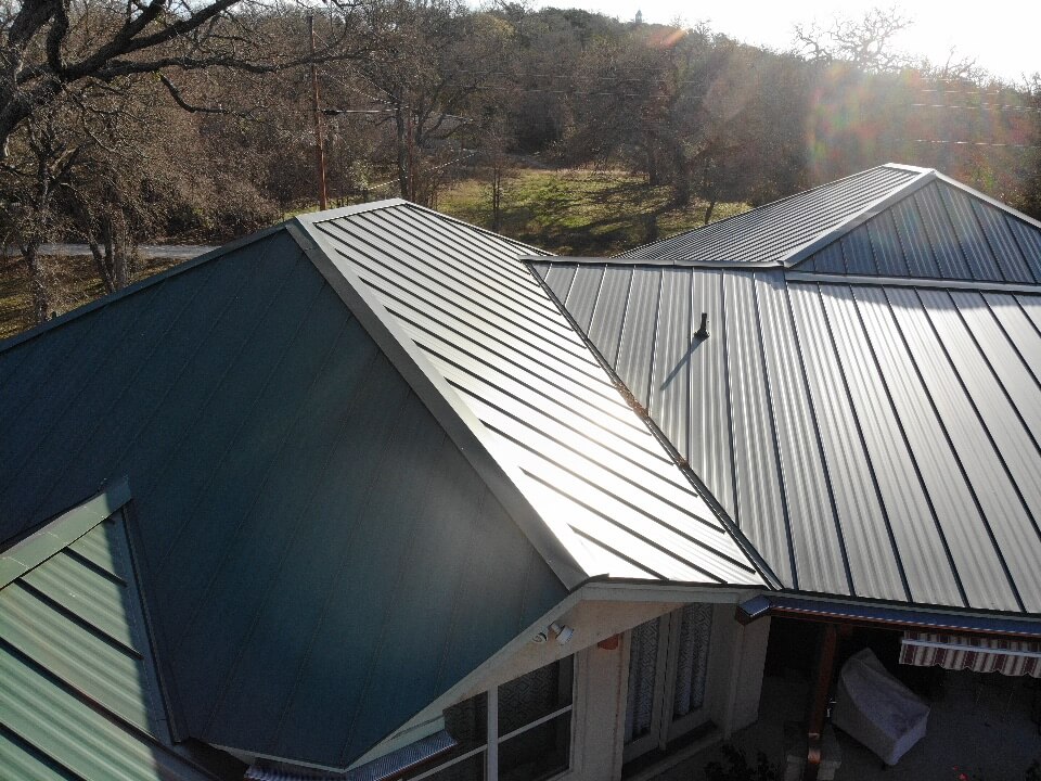 Green metal roof in Burnet with sun reflecting off the high points.