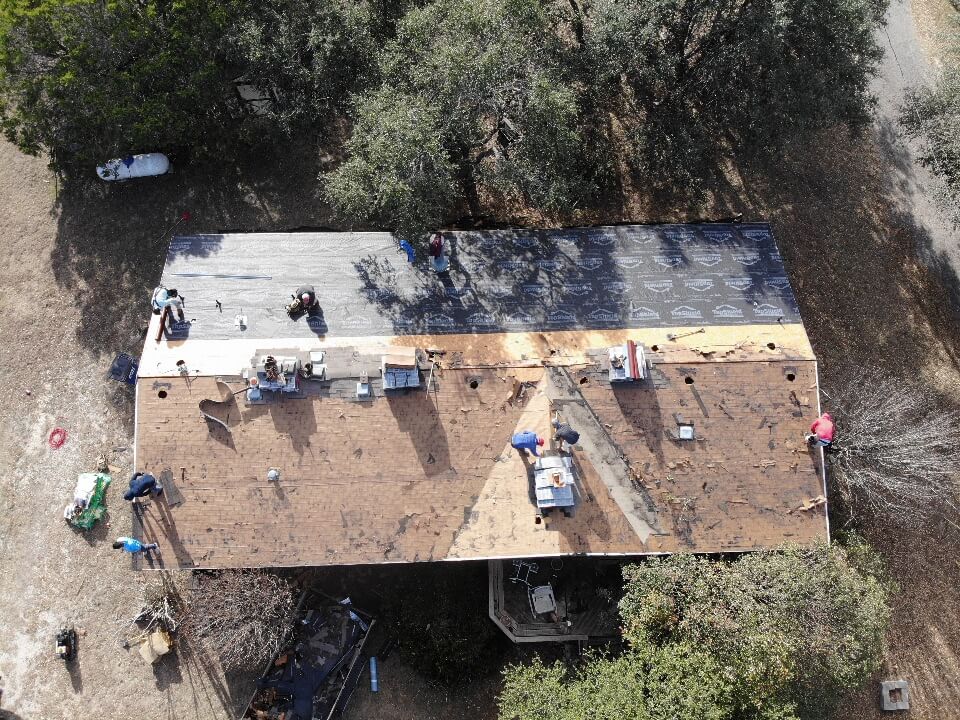 Liberty Hill roofing contractors in the process of installing a new residential roof.