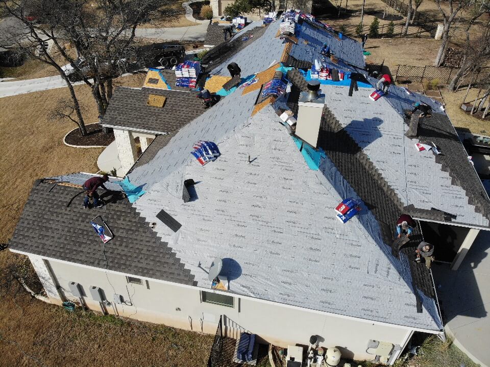 A&W roofing contractors in the process of installing a new roof on a home in Liberty Hill, Texas.