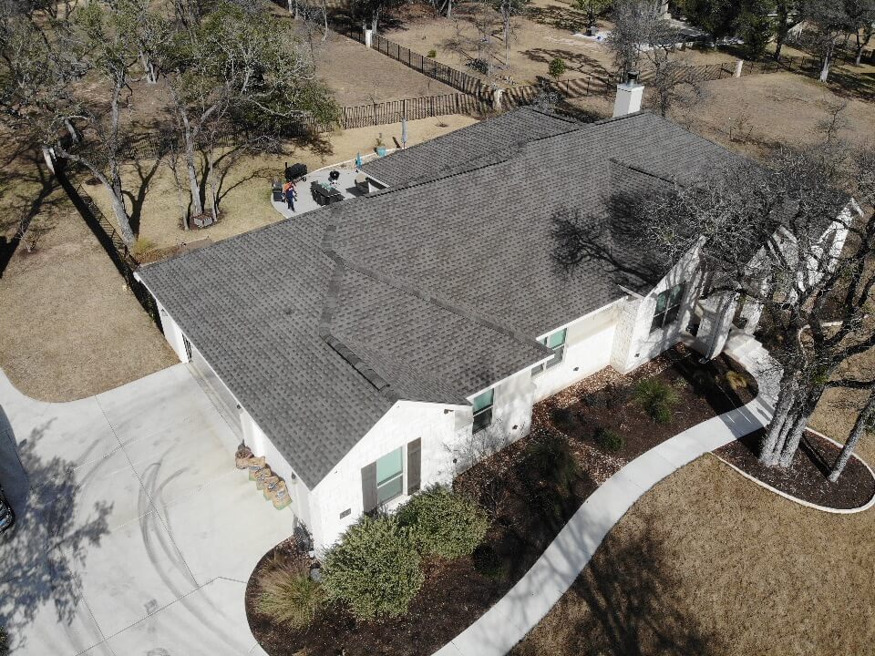 Liberty Hill home with swimming pool and new shingle roof installation.