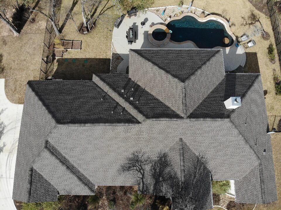 Shingle roof installation on Liberty Hill home with swimming pool.