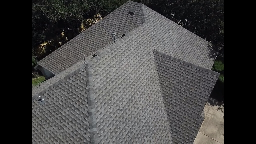 Shingle roof in Pflugerville with trees around the home's perimeter.