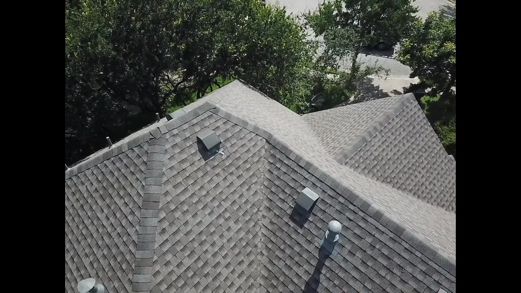 Shingle roof on Pflugerville home with many trees in the yard.