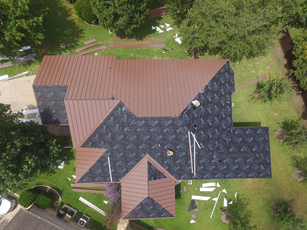 A&W roofing contractors halfway through the process of installing a metal roof on a home in Georgetown.