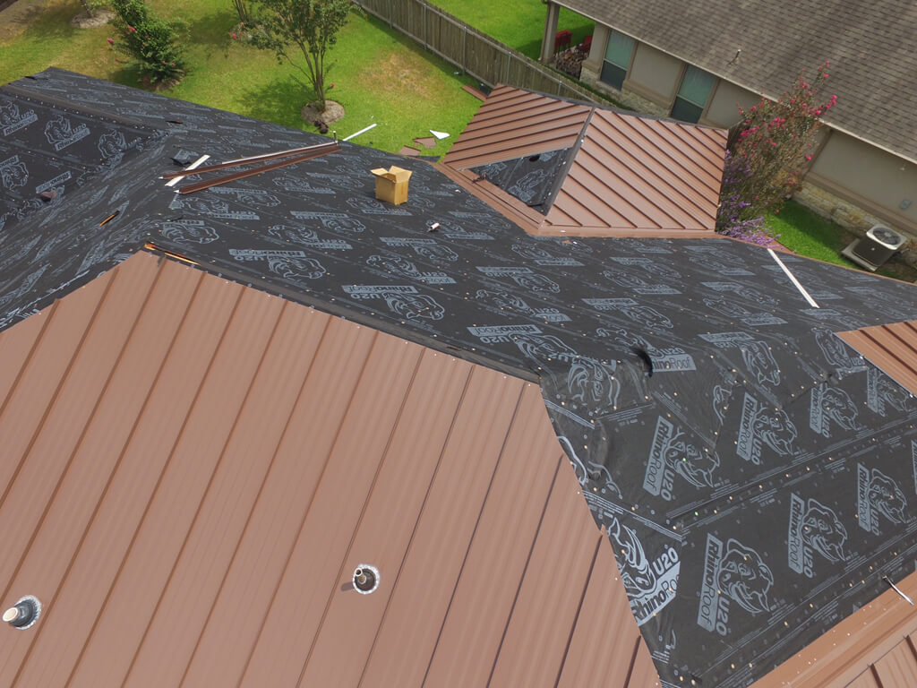 Brown metal roof with black tarp as the rest of the roof is installed on a home in Georgetown.