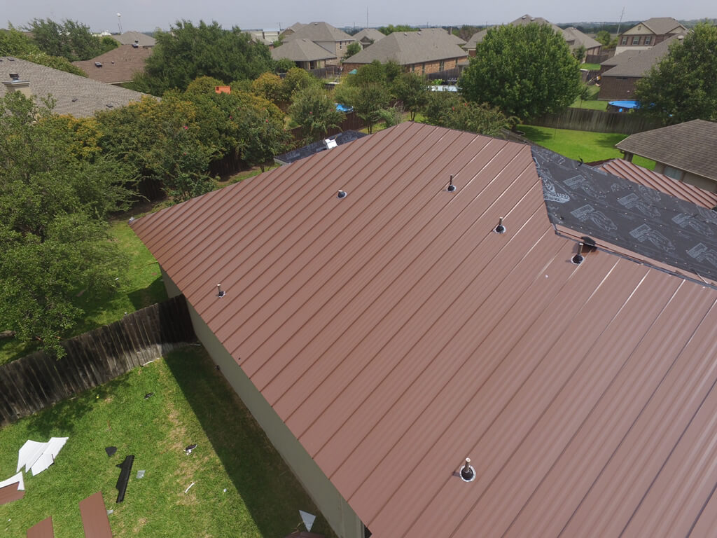 Installation process of a brown metal roof in Georgetown.