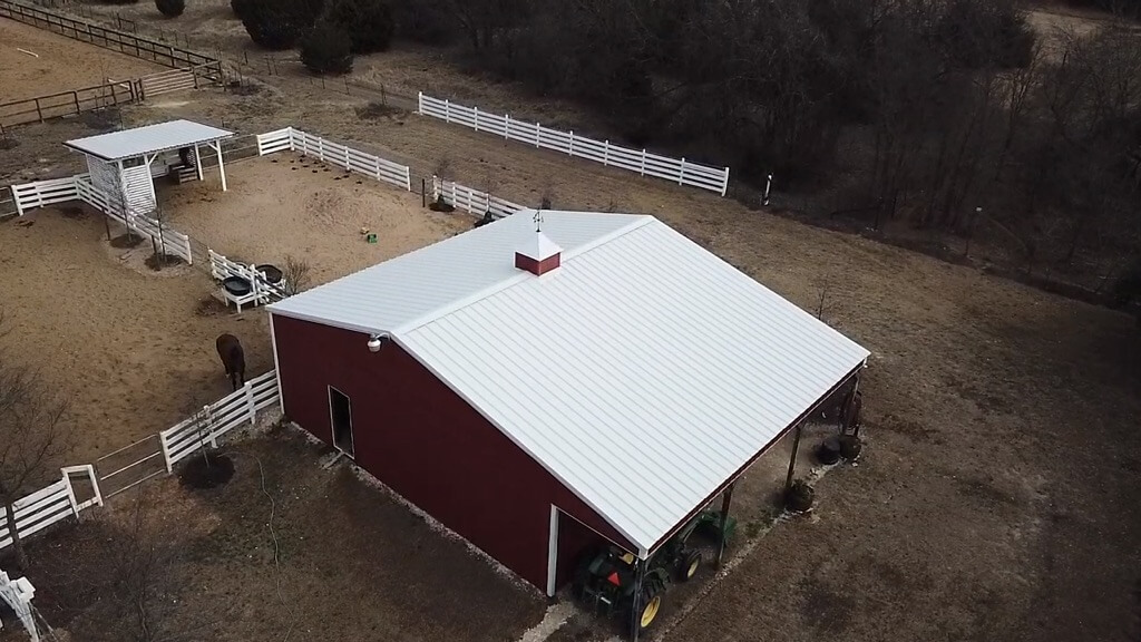 Liberty Hill acreage property with a barn and horse corral that both have metal roofing.