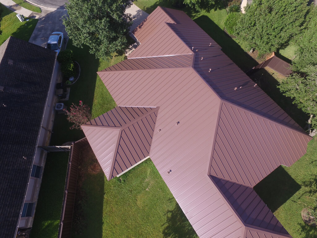 Red colored metal roof on Georgetown home installed by the roofing contractors at A&W.