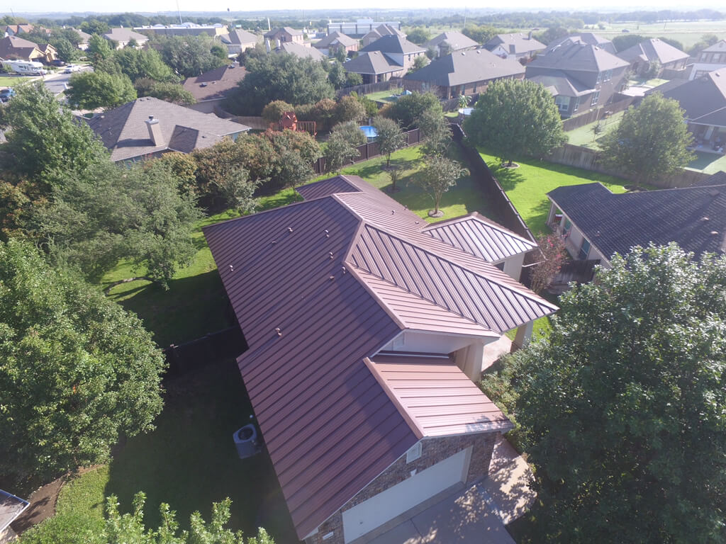 Red metal roof in Georgetown installed by the contractors at A&W roofing.
