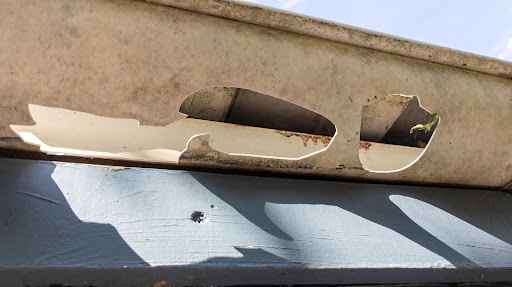 Damaged gutter with holes in it after severe weather hail storm in Central Texas.
