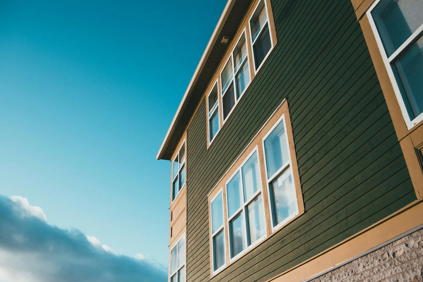 Green horizontal lap siding on home in Austin, Texas.
