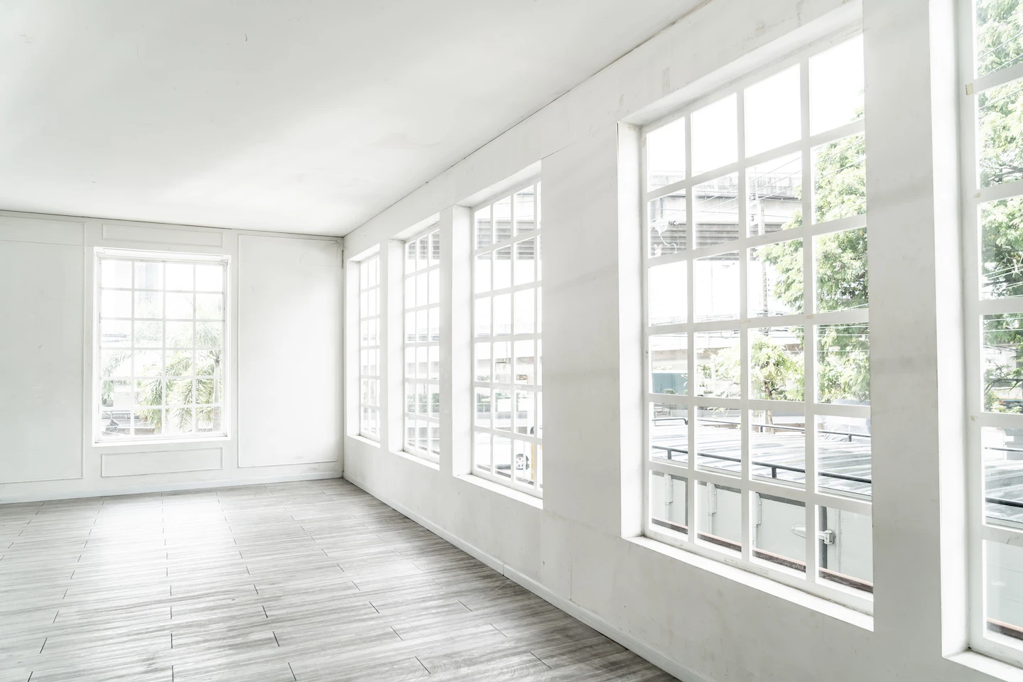 Empty home in Austin with gray flooring, white walls, and energy-efficient windows.