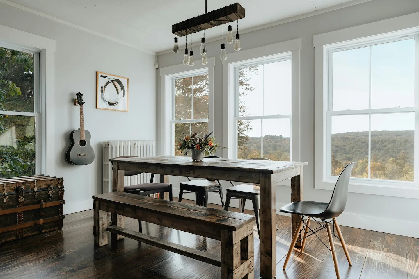 Dining room of home in Austin with low-e windows and wooden dining table.
